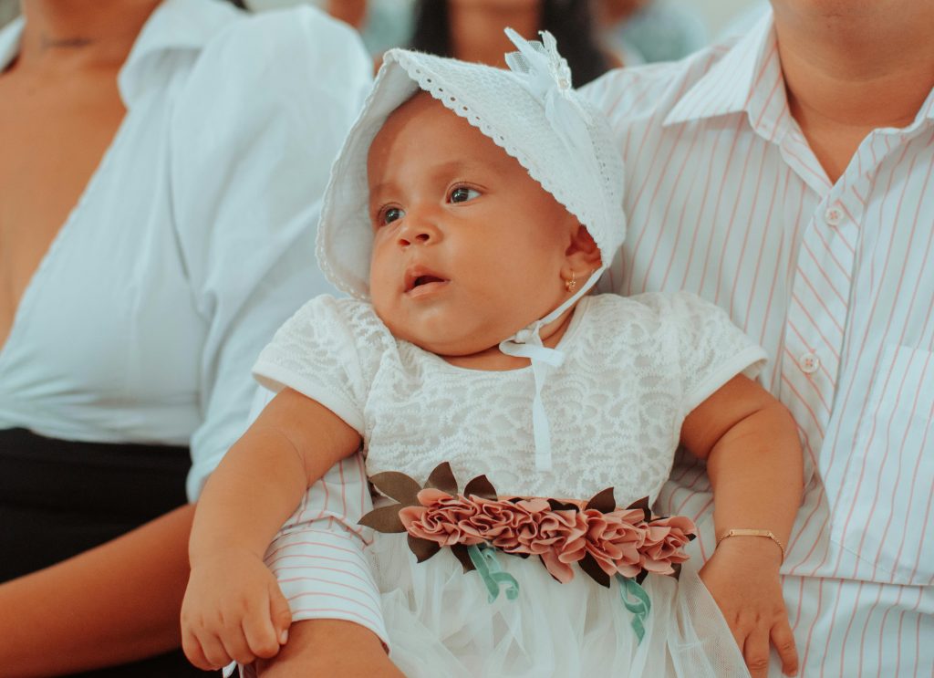 Baby girl dressed for a ceremony